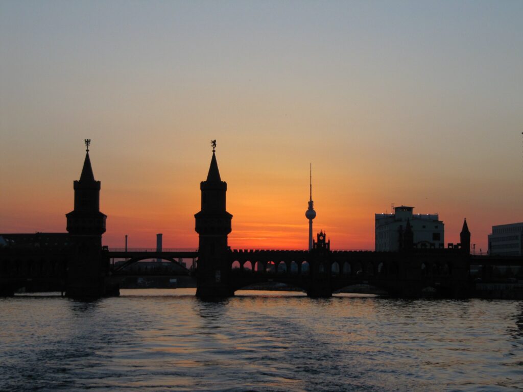 Silhouette of Bridge on Body of Water during Golden Hour